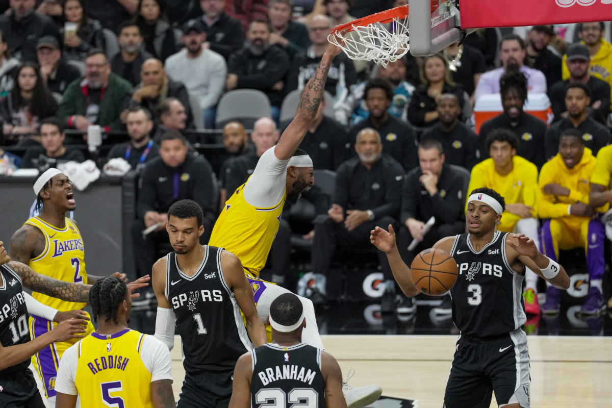 Dec 13, 2023; San Antonio, Texas, USA; Los Angeles Lakers forward Anthony Davis (3) dunks in front of San Antonio Spurs center Victor Wembanyama (1) and forward Keldon Johnson (3) in the first half at the Frost Bank Center.